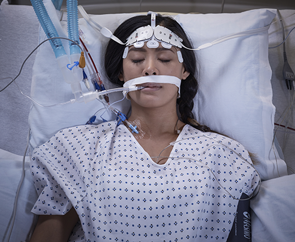 Patient in hospital bed intubated wearing Masimo O3 Sensors